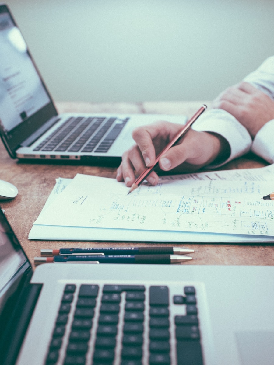 Executive reviewing plans and metrics at a desk